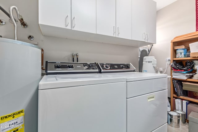 laundry room with cabinets, separate washer and dryer, gas water heater, and hardwood / wood-style flooring