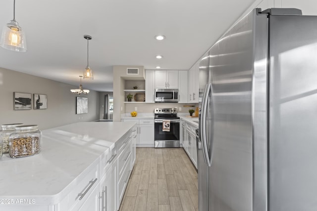 kitchen with open shelves, appliances with stainless steel finishes, hanging light fixtures, and white cabinetry