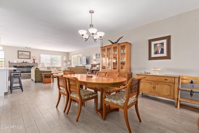 dining space with a notable chandelier and light wood-type flooring