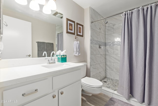 bathroom with hardwood / wood-style floors, vanity, toilet, and a shower with curtain