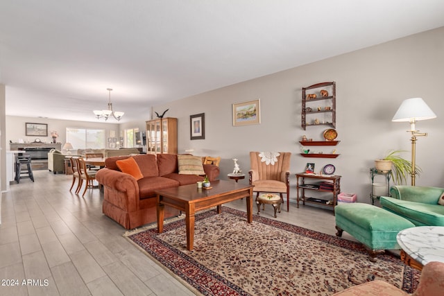 living room with light wood-type flooring and a chandelier