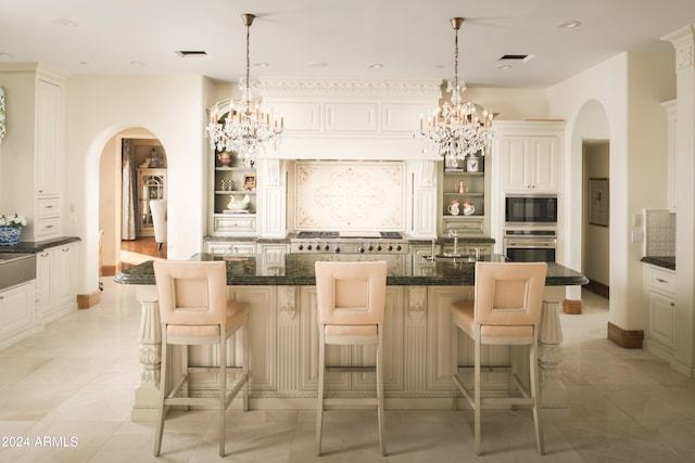 kitchen with pendant lighting, a breakfast bar area, and a center island with sink