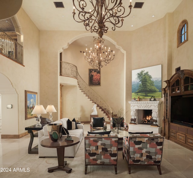 living room featuring a towering ceiling and a notable chandelier