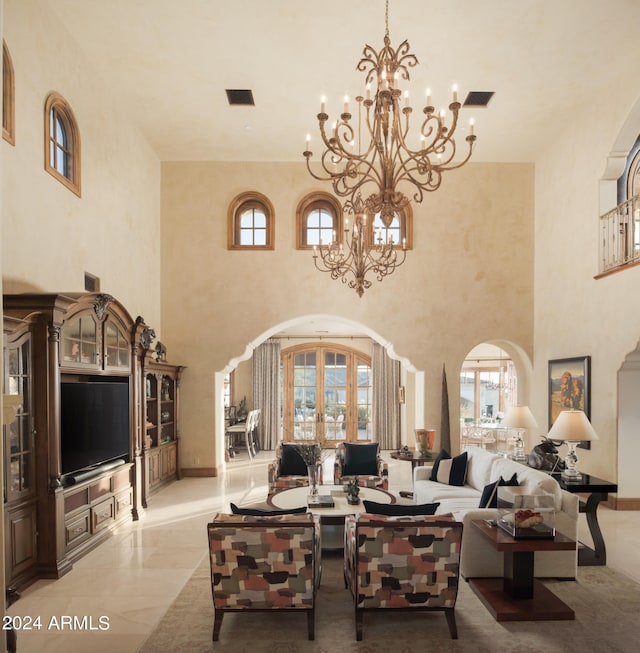 living room featuring an inviting chandelier and a healthy amount of sunlight