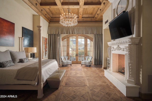 bedroom featuring coffered ceiling, an inviting chandelier, a fireplace, beam ceiling, and french doors