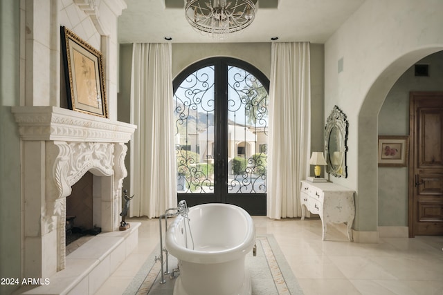 bathroom featuring tile patterned flooring, a tub to relax in, and french doors