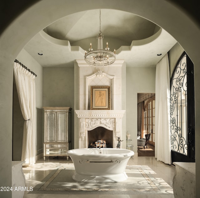 interior space with an inviting chandelier, a tray ceiling, and a fireplace