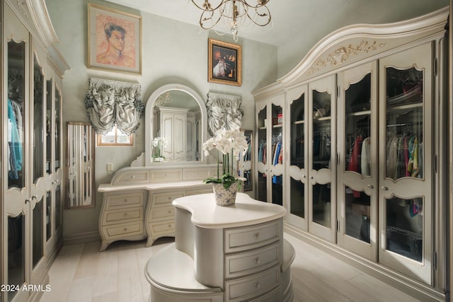 bathroom with wood-type flooring, toilet, a notable chandelier, and french doors