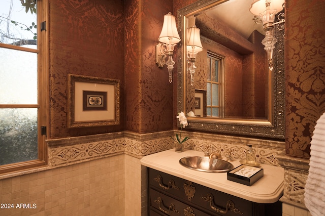 bathroom with vanity and tile walls