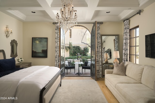 bedroom featuring beamed ceiling, coffered ceiling, crown molding, access to outside, and light hardwood / wood-style floors