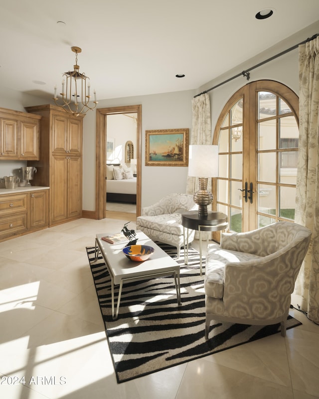 living room featuring a chandelier, light tile patterned flooring, and french doors