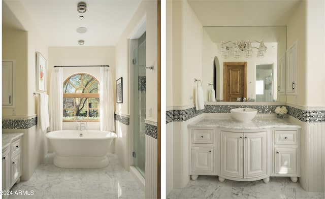 bathroom with vanity, separate shower and tub, and tile walls