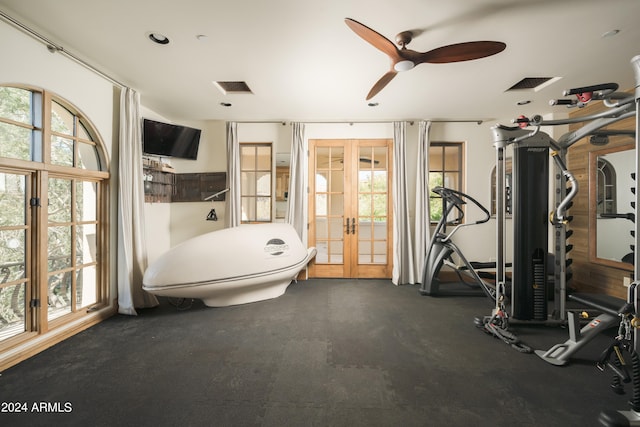 bathroom featuring french doors, toilet, a wealth of natural light, and ceiling fan