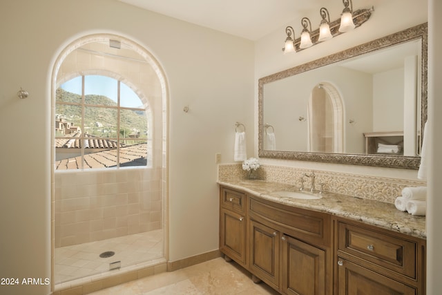 bathroom featuring a shower, tile patterned floors, a mountain view, and vanity