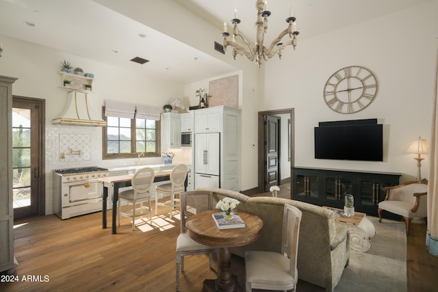 living room with an inviting chandelier and light hardwood / wood-style floors