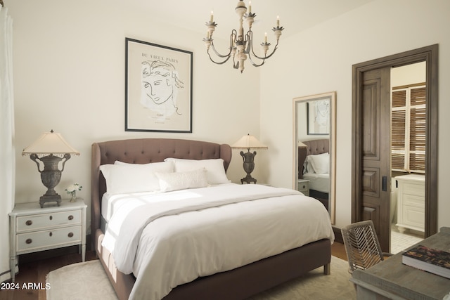 bedroom with hardwood / wood-style flooring and a chandelier