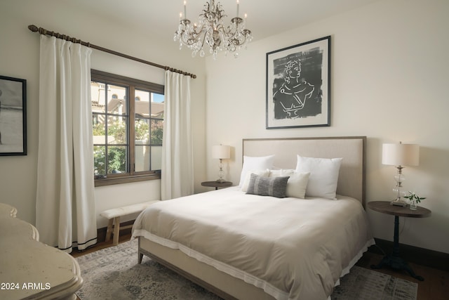 bedroom featuring wood-type flooring and a chandelier