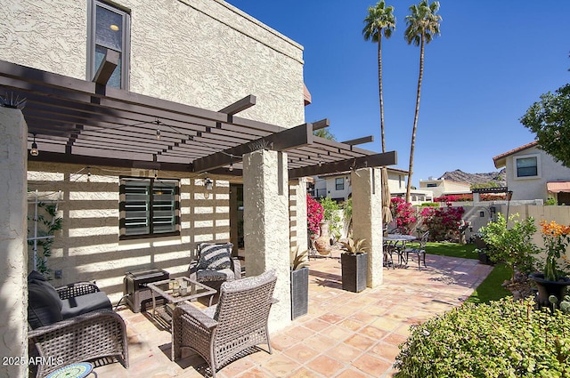 view of patio featuring a pergola and fence