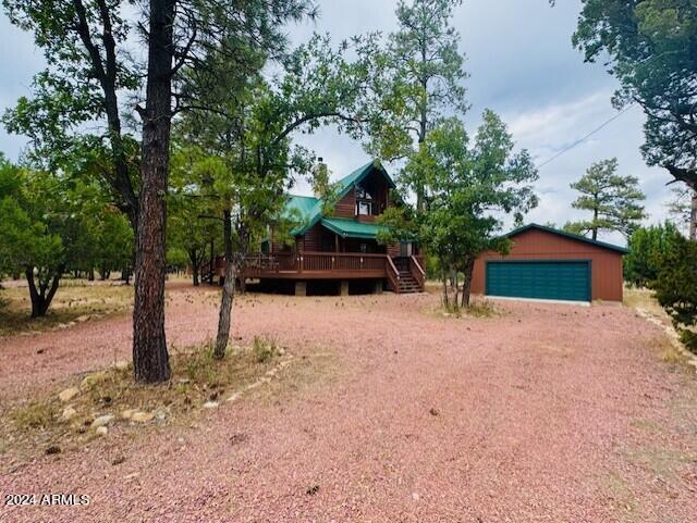 view of front of home with an outdoor structure and a garage