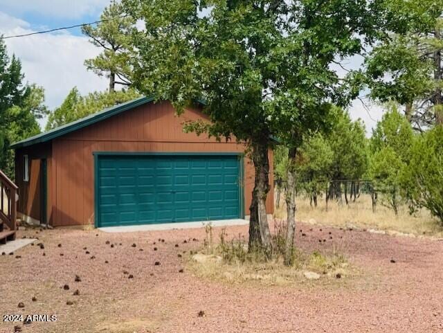 garage featuring wood walls