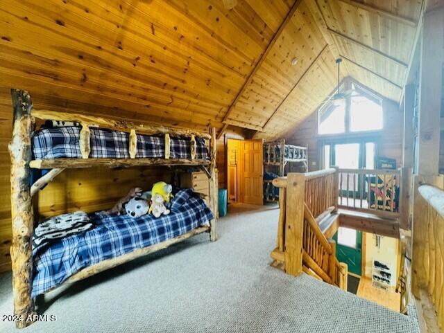 bedroom featuring vaulted ceiling, wooden ceiling, and carpet flooring