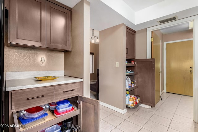 kitchen featuring an inviting chandelier and light tile patterned floors