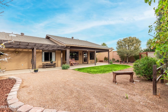 back of property with a patio