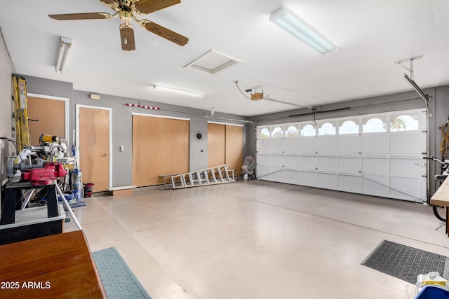 garage with a garage door opener and ceiling fan