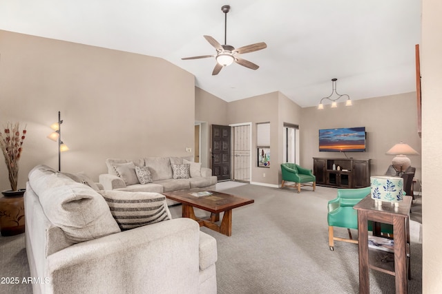 living room featuring lofted ceiling, carpet flooring, and ceiling fan with notable chandelier