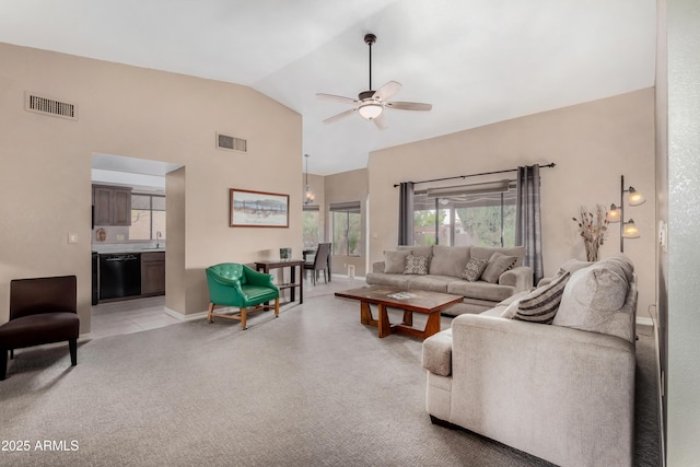 carpeted living room featuring ceiling fan, vaulted ceiling, and sink