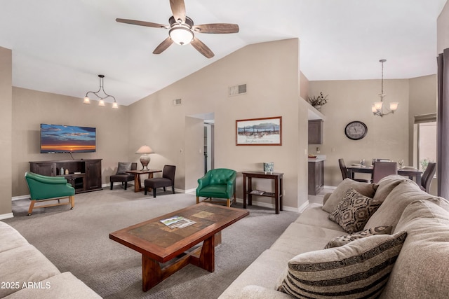 carpeted living room featuring vaulted ceiling and ceiling fan with notable chandelier