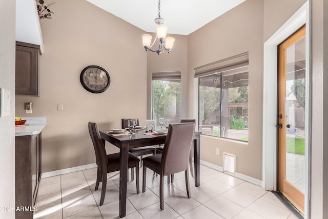 dining room with light tile patterned flooring and a chandelier