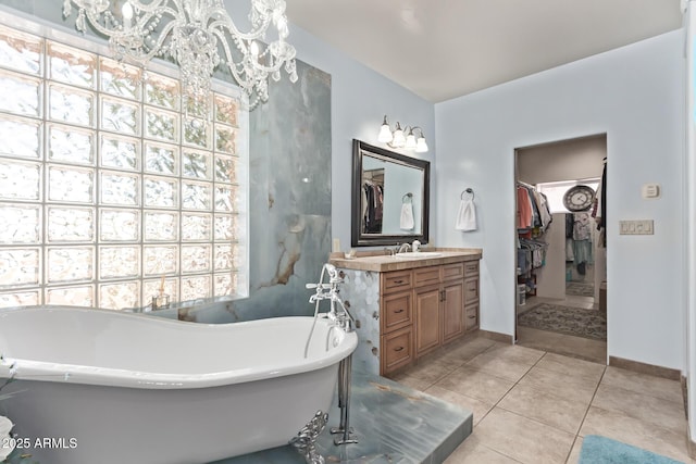 380 N Geneva Estates Rd, Pearce, AZ 85625 - full bathroom featuring a spacious closet, vanity, a soaking tub, tile patterned flooring, and plenty of natural light