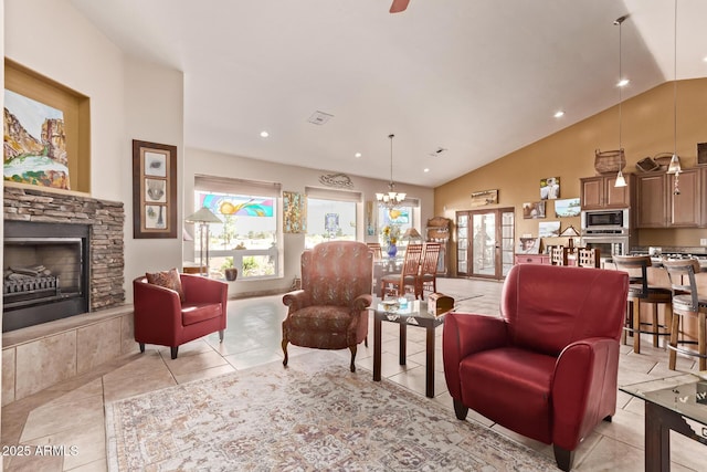 380 N Geneva Estates Rd, Pearce, AZ 85625 - living room with lofted ceiling, a stone fireplace, a chandelier, and light tile patterned floors