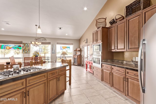 380 N Geneva Estates Rd, Pearce, AZ 85625 - kitchen featuring appliances with stainless steel finishes, vaulted ceiling, light tile patterned floors, hanging light fixtures, and brown cabinetry