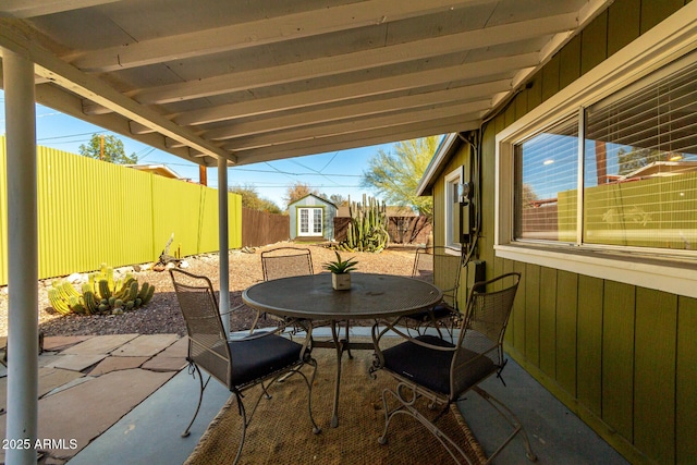 view of patio featuring a storage shed