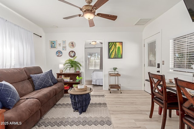 living room featuring ceiling fan and light hardwood / wood-style flooring