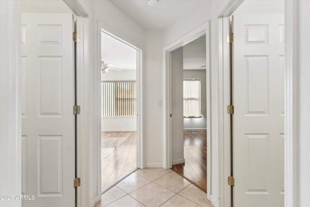 hall featuring light tile patterned flooring