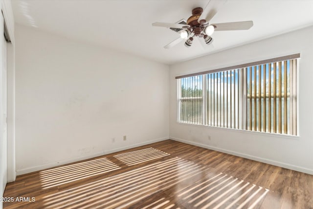 unfurnished room featuring hardwood / wood-style floors and ceiling fan