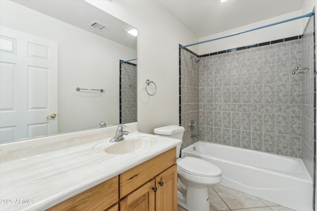 full bathroom with vanity, tile patterned flooring, toilet, and tiled shower / bath combo