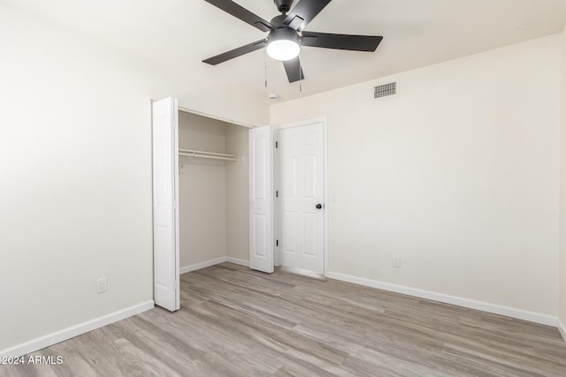 unfurnished bedroom featuring ceiling fan, light hardwood / wood-style floors, and a closet