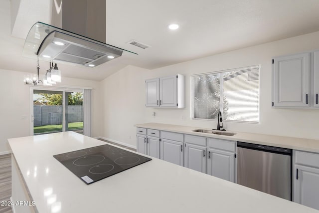 kitchen with black electric stovetop, stainless steel dishwasher, sink, decorative light fixtures, and hardwood / wood-style floors