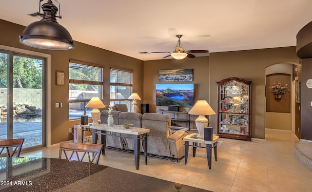 living room with ceiling fan and light tile patterned floors