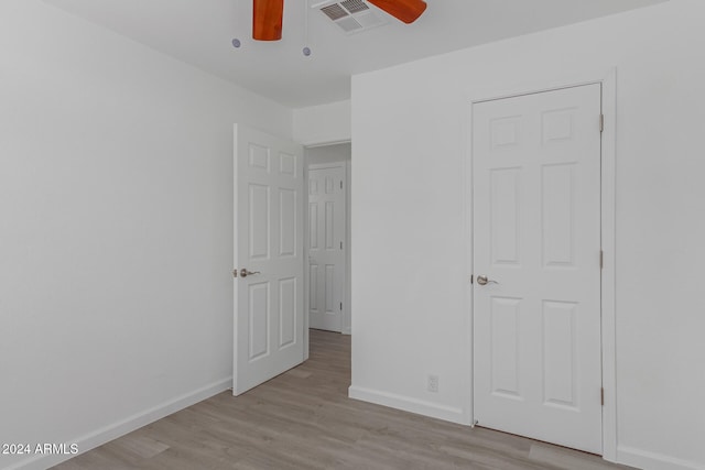 unfurnished bedroom featuring ceiling fan and light hardwood / wood-style flooring