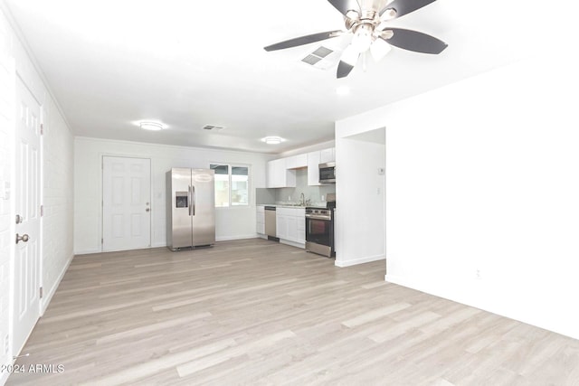 unfurnished living room with ceiling fan, sink, and light wood-type flooring