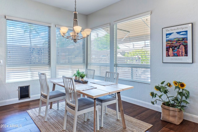 dining space with a notable chandelier, dark hardwood / wood-style floors, and a healthy amount of sunlight