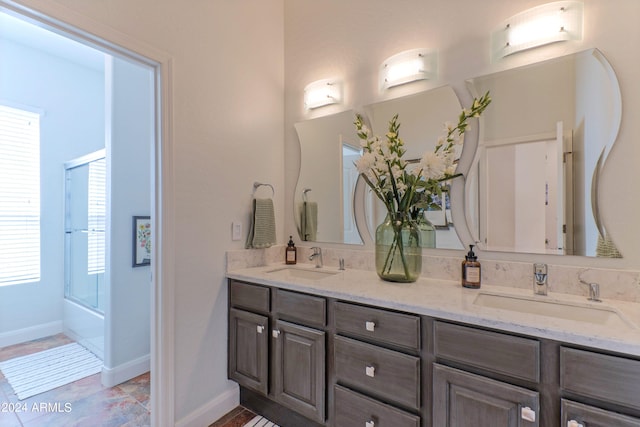 bathroom featuring vanity and combined bath / shower with glass door