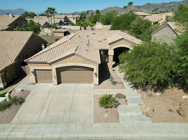 view of front of home featuring a mountain view and a garage