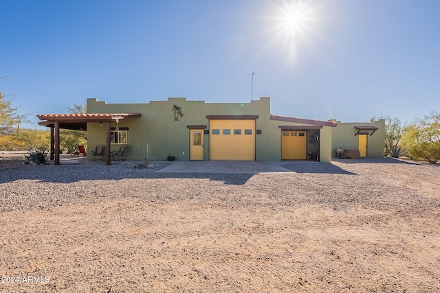 pueblo-style home featuring a garage