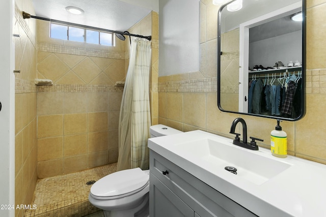 bathroom featuring a shower with shower curtain, vanity, toilet, and tile walls